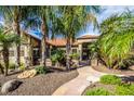 Inviting desert-landscaped front yard with a winding stone pathway to the gated courtyard at 16446 N 59Th St, Scottsdale, AZ 85254