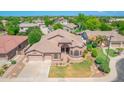 An aerial view of a single-story home with a well-manicured lawn and three-car garage at 2068 S Sailors Ct, Gilbert, AZ 85295