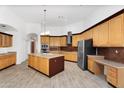 A well-appointed kitchen with an island, built-in desk, and stainless appliances at 2068 S Sailors Ct, Gilbert, AZ 85295