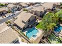Aerial view of a private backyard oasis with pool, spa, patio, and lush landscaping at 2108 E Tecoma Rd, Phoenix, AZ 85048