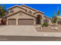 Charming home with a tile roof, desert landscaping, and a three-car garage at 2108 E Tecoma Rd, Phoenix, AZ 85048