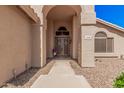 Inviting front entry featuring an arched entryway and custom double doors at 2108 E Tecoma Rd, Phoenix, AZ 85048