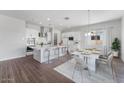 Open concept kitchen with island seating, stainless steel appliances, and adjacent dining area at 21539 S 191St Pl, Queen Creek, AZ 85140