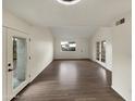 Spacious living room featuring wood flooring and glass doors leading to the outdoors at 2155 W Farmdale Ave # 24, Mesa, AZ 85202