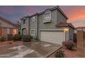 Charming two-story home with a two-car garage, desert landscaping, and a beautiful sunrise at 21860 N 41St St, Phoenix, AZ 85050