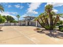 Wide driveway featuring a luxury home with 3 car garage and desert landscaping at 2251 N 32Nd St # 31, Mesa, AZ 85213
