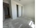 Spacious unfinished bedroom with closet and natural light at 22824 E Roundup Way, Queen Creek, AZ 85142