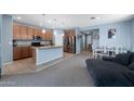 Open kitchen flows into the living room with granite countertops and stainless steel appliances at 35730 N Pommel Pl, San Tan Valley, AZ 85144