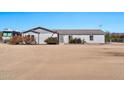 Single story ranch house with a desert landscape, rock garden, and flag pole at 404 W Galvin St, Phoenix, AZ 85086