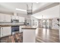 Bright kitchen features white cabinets, stainless steel appliances, and a skylight at 404 W Galvin St, Phoenix, AZ 85086
