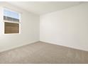 Clean, carpeted bedroom with a window providing natural light at 4332 W Hannah St, San Tan Valley, AZ 85144