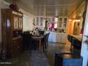 Traditional dining room with a dark wood table and chairs, mirrored cabinets, and elegant decor at 5201 W Camelback Rd # Ofc, Phoenix, AZ 85031