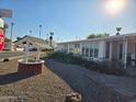 A well-maintained single-story home with desert landscaping and mature palm trees at 5201 W Camelback Rd # Ofc, Phoenix, AZ 85031