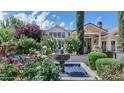Serene front yard with a beautiful fountain surrounded by rose bushes at 5431 E Lafayette Blvd, Phoenix, AZ 85018