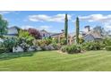 Expansive front yard featuring manicured lawn and colorful rose bushes at 5431 E Lafayette Blvd, Phoenix, AZ 85018