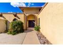 Beautiful house featuring an arched entry with a pair of carved, dark-wood doors at 7656 W Wagoner Rd, Glendale, AZ 85308