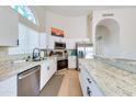 Modern kitchen features white cabinets, stainless steel appliances, granite countertops, and lots of natural light at 832 N Blue Marlin Dr, Gilbert, AZ 85234