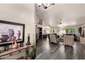 Spacious living room with vaulted ceilings, a ceiling fan, and an open floor plan at 8336 E Neville Ave, Mesa, AZ 85209