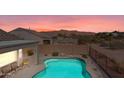 Inviting backyard pool featuring desert landscaping, an outdoor living space, and mountain views at 8377 S Mountain Air Ln, Gold Canyon, AZ 85118