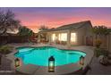 Beautiful backyard pool with decorative lighting and a covered patio for outdoor entertaining at 8377 S Mountain Air Ln, Gold Canyon, AZ 85118