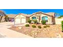 Charming home featuring desert landscaping, blue window shutters, and a tile roof at 9728 E Pantera Ave, Mesa, AZ 85212