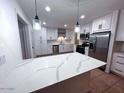 Bright renovated kitchen with quartz counters, stainless steel appliances and white cabinets at 1017 S Lola Ln, Tempe, AZ 85281