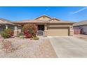 Lovely single-story home boasting a well-manicured front yard with vibrant flowering bushes and desert plants at 10932 E Bella Via --, Mesa, AZ 85212