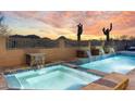 Luxurious pool and spa area with waterfalls and desert views, perfect for relaxation at 11053 E Hedgehog Pl, Scottsdale, AZ 85262