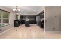 Eat-in kitchen features dark cabinets, a center island, and stainless steel appliances at 1210 E Azure Sea Ln, Gilbert, AZ 85234