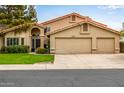 Well-maintained home with a spacious three-car garage and manicured lawn at 15027 N 61St Pl, Scottsdale, AZ 85254
