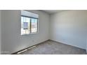 Cozy bedroom with neutral carpet, a window with blinds, and ample natural light at 15784 W Beryl Ave, Waddell, AZ 85355