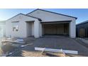 View of the home's exterior showing the driveway and an attached two car garage at 15784 W Beryl Ave, Waddell, AZ 85355