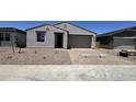 Charming single-story home featuring a stucco facade, landscaped front yard, and a two-car garage at 15784 W Beryl Ave, Waddell, AZ 85355