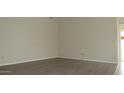 A bright, naturally lit room with plank flooring and neutral colored walls at 20479 N 105Th Ave, Peoria, AZ 85382