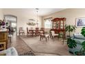 Elegant dining room features a classic table setting, traditional decor, and plush carpeting at 2212 W Calle De Las Estrella St, Phoenix, AZ 85085