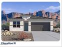 Charming single-story home featuring stone accents, a two-car garage, and desert landscaping with mountain views at 23984 W Cocopah St, Buckeye, AZ 85326