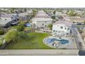 Aerial view of a home with a backyard oasis including a pool with a rock waterfall feature at 30419 N Plantation Dr, San Tan Valley, AZ 85143
