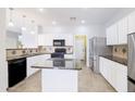 Bright kitchen featuring granite counters, stainless steel appliances and tile flooring at 30419 N Plantation Dr, San Tan Valley, AZ 85143
