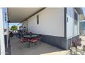 Covered patio with a table and four chairs with comfortable cushions, perfect for outdoor relaxing at 4065 E University Dr # 471, Mesa, AZ 85205