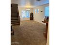 Spacious living room features carpet and a staircase leading to the upper level of the home at 4134 E Bellerive Dr, Chandler, AZ 85249