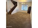 Spacious living room features carpet and a staircase leading to the upper level of the home at 4134 E Bellerive Dr, Chandler, AZ 85249