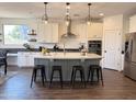 Beautiful kitchen features a gray island with seating and modern lighting at 4381 E Rawhide St, Gilbert, AZ 85296