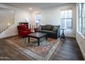 Spacious living room with wood floors, large windows, and stylish furnishings at 4381 E Rawhide St, Gilbert, AZ 85296