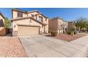 Inviting home with an attached two-car garage, desert landscaping, and a spacious driveway at 45608 W Barbara Ln, Maricopa, AZ 85139
