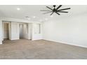Spacious, carpeted room with neutral walls, ceiling fan, and ample natural light, perfect for relaxation at 5100 E Rancho Paloma Dr # 2061, Cave Creek, AZ 85331