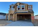 Two-story home under construction featuring a spacious two car garage and a porch at 7417 W Buckhorn Trl, Peoria, AZ 85383