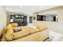 Spacious living room with tiled floors, built-in media center and an open kitchen area at 8187 E Del Caverna Dr, Scottsdale, AZ 85258