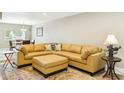 Bright living room with a large tan sectional couch and decorative rug at 8187 E Del Caverna Dr, Scottsdale, AZ 85258