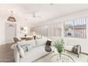 Bright living room with a comfortable white sofa and ample natural light at 8338 E Milagro Ave, Mesa, AZ 85209