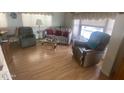 Spacious living room featuring laminate flooring, neutral decor and comfortable furniture at 1147 S Sioux Dr, Apache Junction, AZ 85119